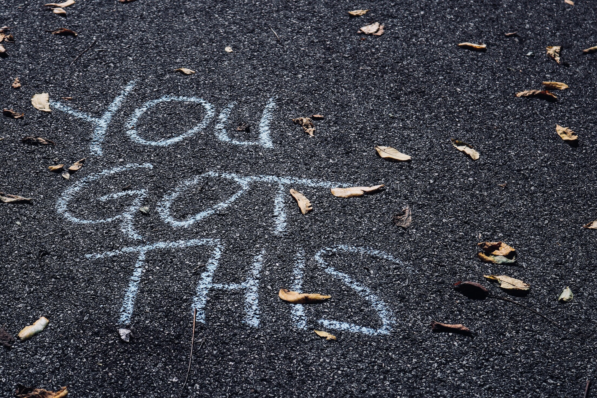 'You Got This' written in chalk on pavement. 