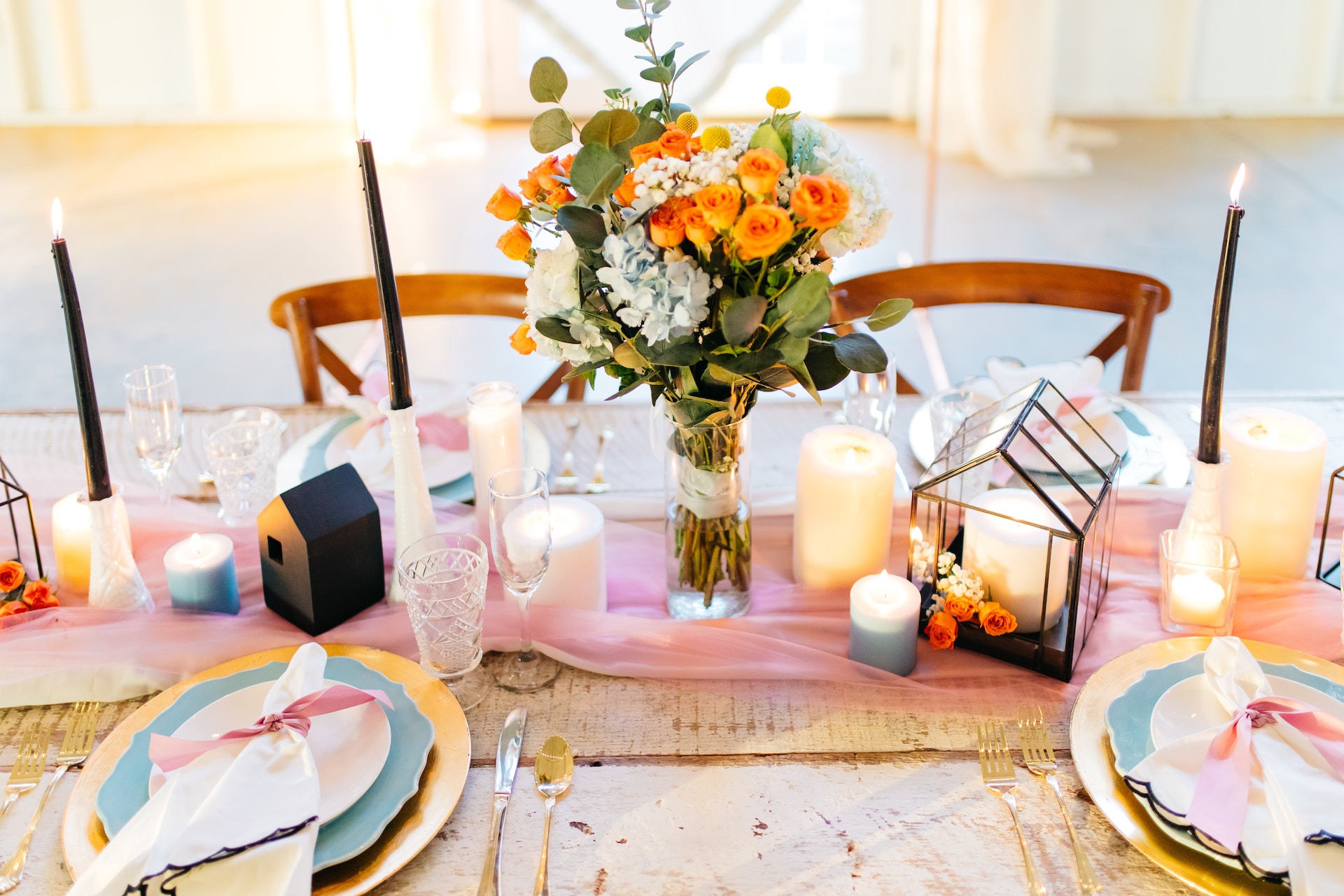 Colourfully laid up table with flower and candles. 
