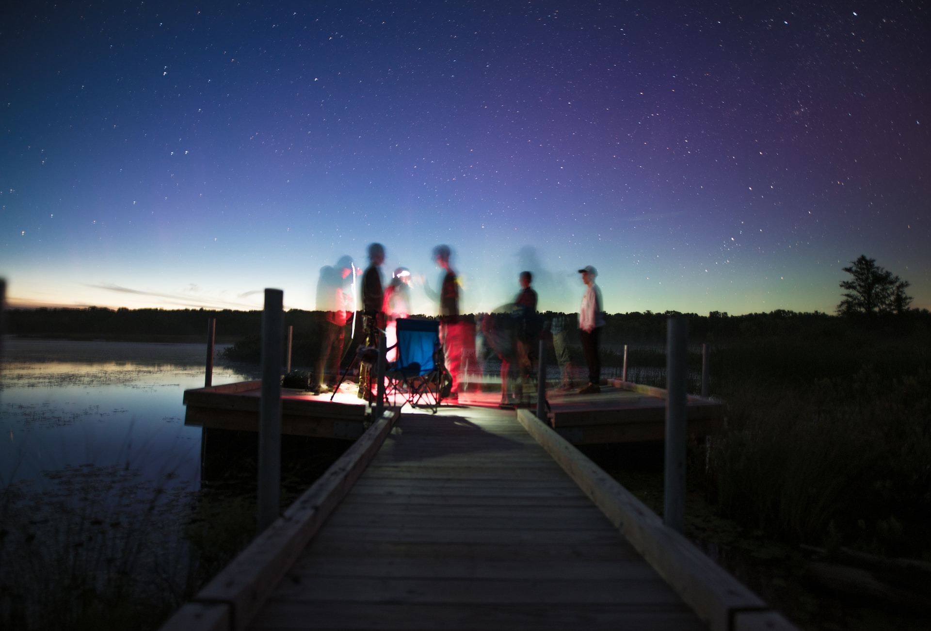 Timelapse of stargazers by a lake