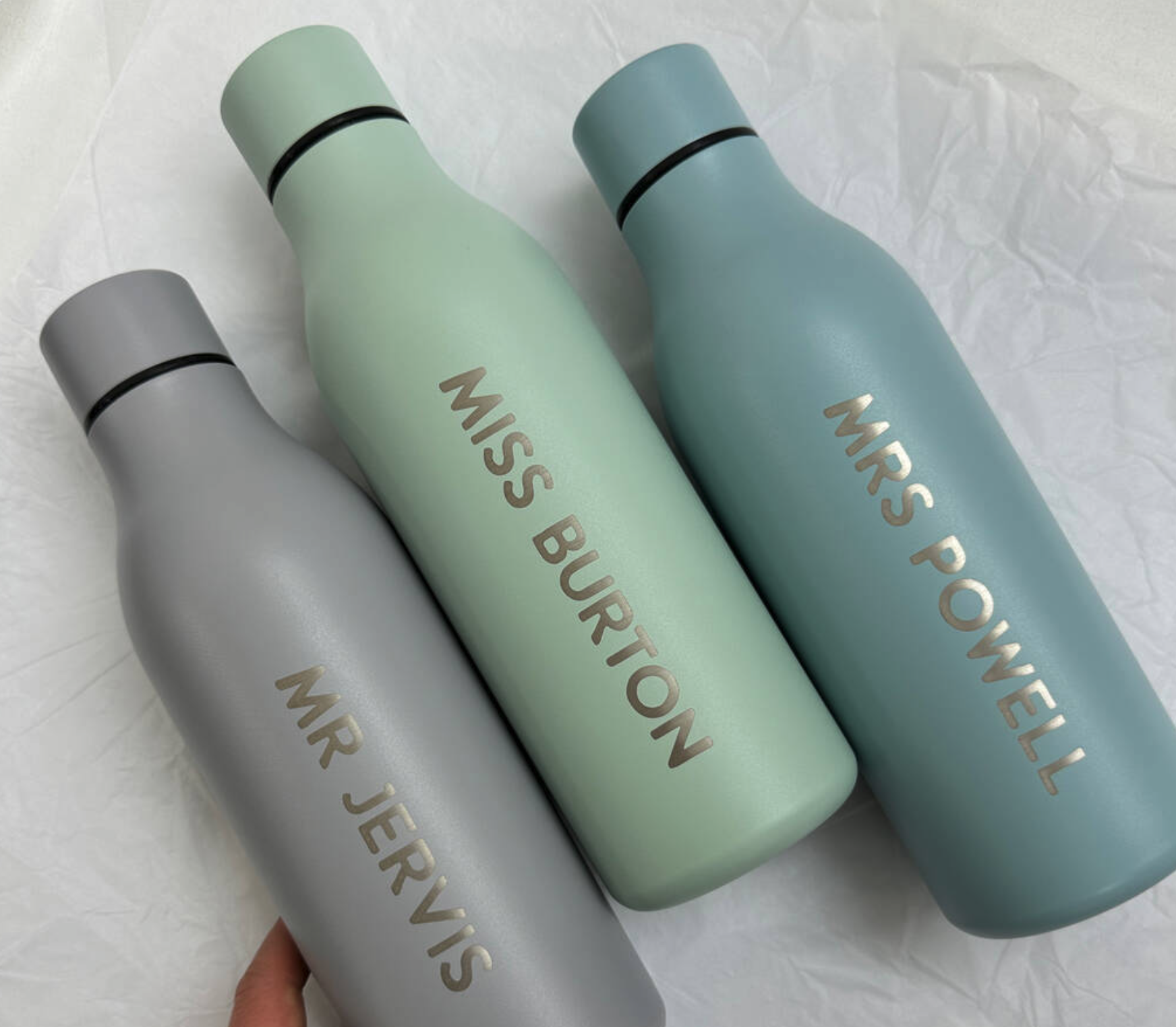 3 personalised Chilly Bottles with teacher's names engraved on them. 