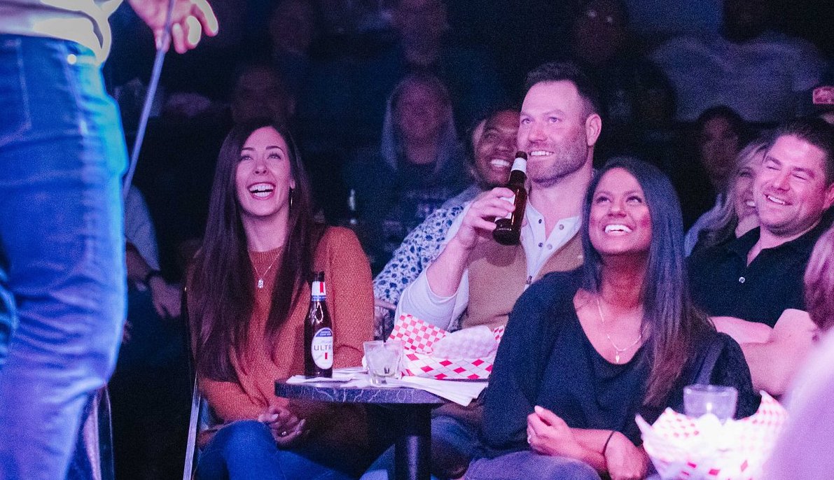 Group of people laughing at a comedy gig. 