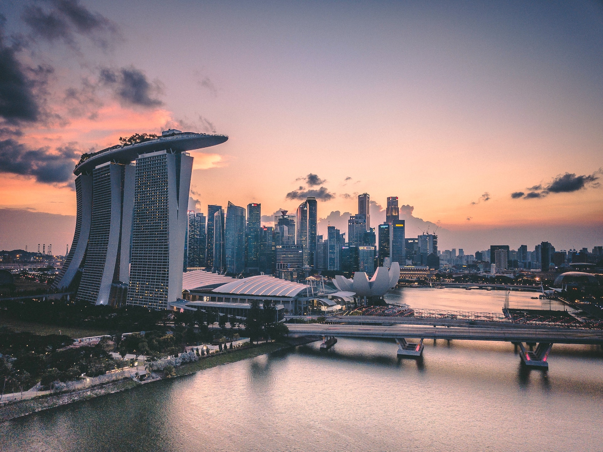 Sunset horizon shot of Singapore city, featuring Marina Bay Sands Hotel and rooftop pool. 