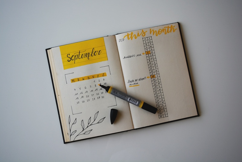 Handwritten diary with yellow highlighter. 