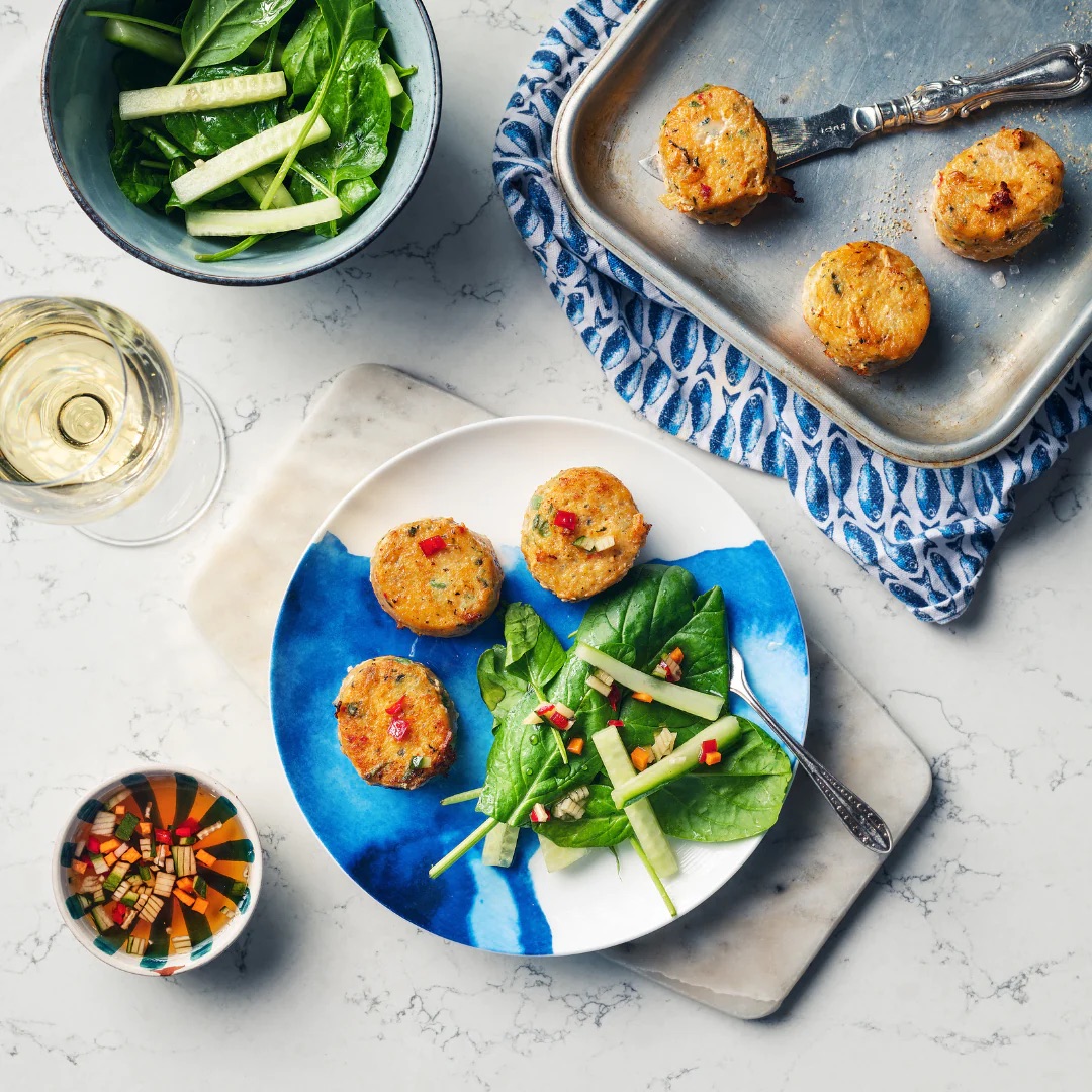 Rick Stein's Indonesian Curry Kit; Thai fishcakes with dipping sauce and green leaves. 