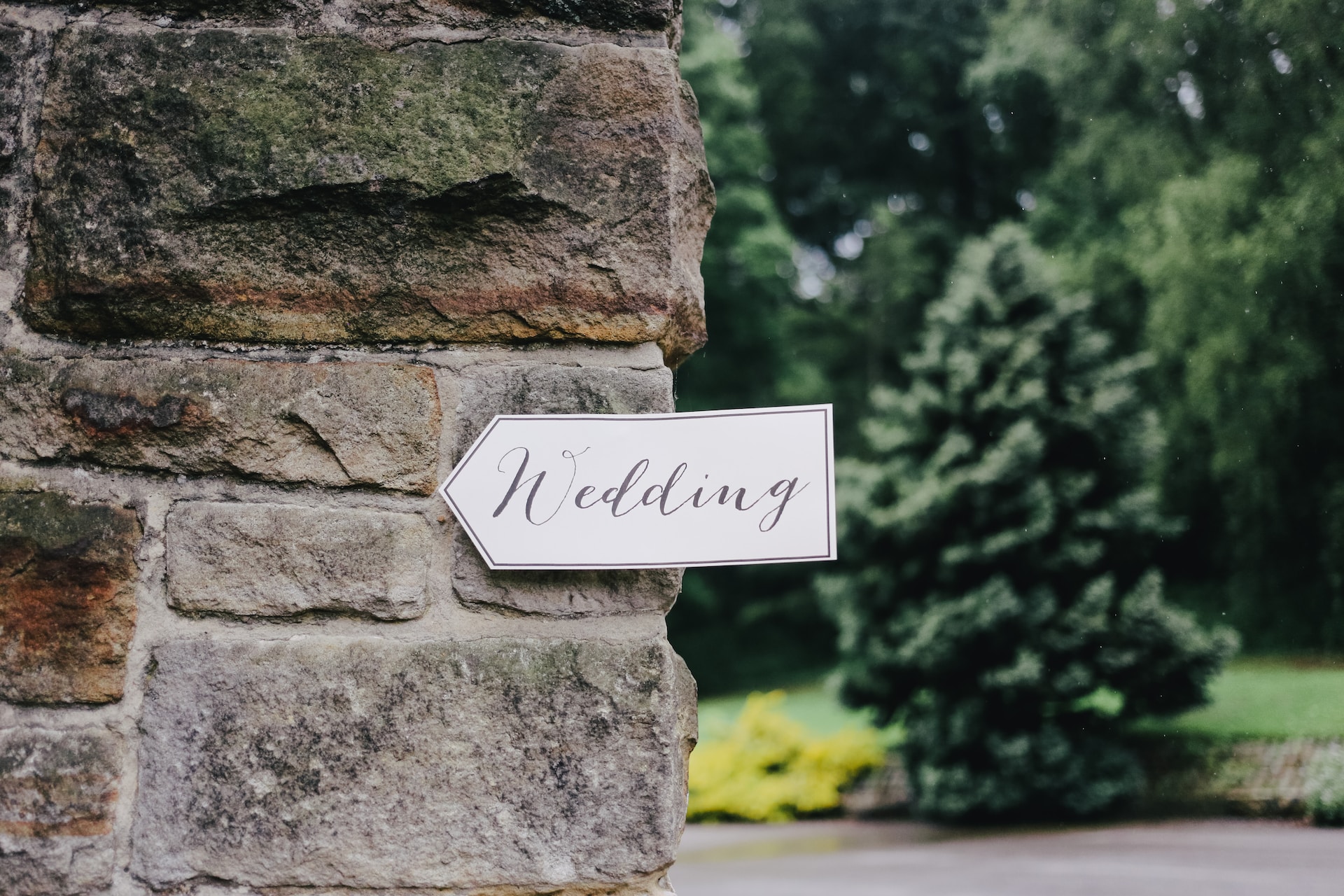 Signpost with 'Wedding' written on it in cursive handwriting. 