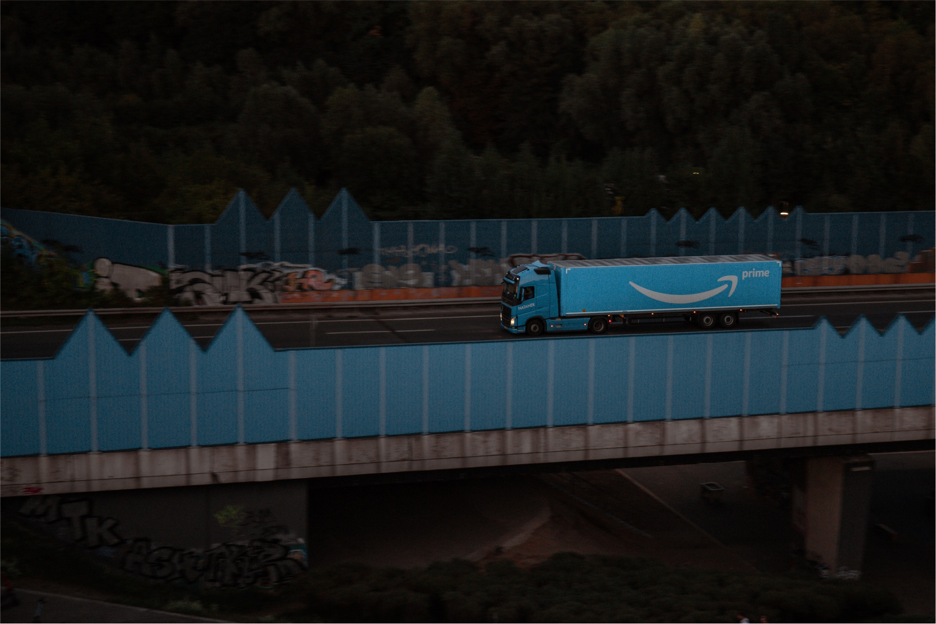 Amazon Prime lorry driving over a bridge. 